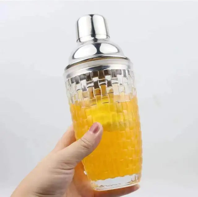 Elegant glass cocktail shaker with built-in strainer and stainless steel lid, for perfectly mixed cocktails.